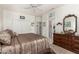 Cozy primary bedroom with a ceiling fan, a comfortable carpet and a vintage dresser with mirror at 16019 W Heritage Dr, Sun City West, AZ 85375