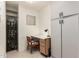 Small, bright office space with wine rack and rolling chair at 16019 W Heritage Dr, Sun City West, AZ 85375
