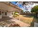 Covered backyard patio with a spacious yard and mature orange tree at 1743 N Dresden --, Mesa, AZ 85203