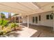 View of the home's backyard patio with palm trees, ceiling fan, and french doors at 1743 N Dresden --, Mesa, AZ 85203