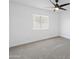 Well-lit bedroom with neutral carpet, ceiling fan, and a bright window at 1743 N Dresden --, Mesa, AZ 85203