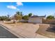 Exterior showcasing the house, driveway, and a well-kept lawn with mature trees at 1743 N Dresden --, Mesa, AZ 85203