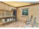 Private back patio with covered seating area, brick flooring, and relaxing outdoor decor at 17530 W Oberlin Way, Surprise, AZ 85387