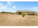 View of a spacious backyard with desert landscaping and a covered patio, perfect for outdoor living at 17530 W Oberlin Way, Surprise, AZ 85387