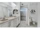 Elegant bathroom with a double sink vanity, tiled shower with glass door, and modern fixtures at 17530 W Oberlin Way, Surprise, AZ 85387