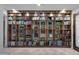 A large, custom bookshelf with glass shelves, filled with a wide variety of books at 17530 W Oberlin Way, Surprise, AZ 85387