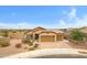 Gorgeous home featuring a spacious three-car garage, desert landscaping, and a welcoming entrance at 17530 W Oberlin Way, Surprise, AZ 85387