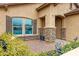 Exterior view showcasing stone accents, window shutters and drought tolerant landscaping at 17530 W Oberlin Way, Surprise, AZ 85387