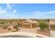 Aerial view of a beautiful home boasting a three-car garage, desert landscaping, and a tile roof at 17530 W Oberlin Way, Surprise, AZ 85387