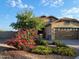 Charming single-story home with a landscaped front yard, colorful shrubbery and attached two-car garage at 17530 W Oberlin Way, Surprise, AZ 85387