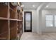 Bright hallway with a decorative glass front door and a floor-to-ceiling bookshelf at 17530 W Oberlin Way, Surprise, AZ 85387