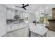 Open kitchen with white cabinets, a granite island, and modern stainless steel appliances at 17530 W Oberlin Way, Surprise, AZ 85387