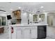 Modern kitchen island featuring white cabinetry, granite countertops, and stylish pendant lighting at 17530 W Oberlin Way, Surprise, AZ 85387