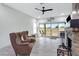 Cozy living room featuring a stone fireplace, comfortable seating, and sliding glass doors at 17530 W Oberlin Way, Surprise, AZ 85387