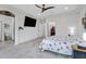 Bright main bedroom featuring tiled floors, a ceiling fan, and a walk-in closet at 17530 W Oberlin Way, Surprise, AZ 85387