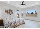 Spacious main bedroom with tiled floor, ceiling fan, and windows with a view at 17530 W Oberlin Way, Surprise, AZ 85387