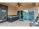 Relaxing covered patio featuring a hot tub, ceiling fan, and sliding glass doors at 17530 W Oberlin Way, Surprise, AZ 85387