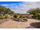 Beautifully landscaped backyard featuring a built-in BBQ area and rock water feature at 17846 W Fairview St, Goodyear, AZ 85338