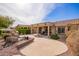 Inviting backyard with flagstone patio, built-in grill, lush landscaping, and a covered outdoor space at 17846 W Fairview St, Goodyear, AZ 85338