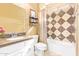 Cozy bathroom featuring a vanity with granite countertop and a shower-tub with patterned tile surround at 17846 W Fairview St, Goodyear, AZ 85338