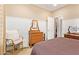 Bedroom with wainscoting, wood furniture, and comfortable seating, offering a relaxing atmosphere at 17846 W Fairview St, Goodyear, AZ 85338