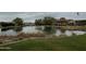 Scenic community pond with a walking bridge and lush surroundings at 17846 W Fairview St, Goodyear, AZ 85338