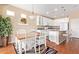 Cozy dining area adjacent to the kitchen, featuring hardwood floors and backyard views at 17846 W Fairview St, Goodyear, AZ 85338