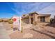 Charming single-story home boasts a stone-accented facade, three-car garage, and low-maintenance desert landscaping at 17846 W Fairview St, Goodyear, AZ 85338