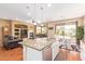 Open concept kitchen with island, stainless steel appliances, and adjacent living and dining areas at 17846 W Fairview St, Goodyear, AZ 85338