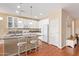 Bright and airy kitchen with white cabinets, granite countertops, and a breakfast bar at 17846 W Fairview St, Goodyear, AZ 85338