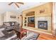 Stylish living room featuring a fireplace and built-in media center at 17846 W Fairview St, Goodyear, AZ 85338