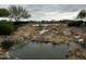 Community stream view with rocks, water, and foliage at 17846 W Fairview St, Goodyear, AZ 85338