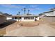 Spacious backyard featuring a patio, a decorative circular garden area, and views of the home's exterior at 1801 W 5Th Pl, Mesa, AZ 85201