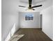 Clean bedroom featuring neutral carpet, a ceiling fan, and a window with a view of the neighborhood at 1801 W 5Th Pl, Mesa, AZ 85201