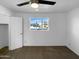 Bedroom with a ceiling fan and a view to the outdoors through the window at 1801 W 5Th Pl, Mesa, AZ 85201