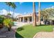 Backyard with a pool, palm trees, and desert landscaping at 18701 N Diamond Dr, Surprise, AZ 85374