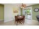 Cozy dining area with a sliding glass door leading to the backyard patio and neutral color scheme at 18701 N Diamond Dr, Surprise, AZ 85374