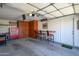 Well-organized garage featuring custom cabinets, a workbench, and space for parking with room for tools and projects at 18701 N Diamond Dr, Surprise, AZ 85374