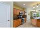 Well-lit kitchen features stainless steel appliances, wood cabinetry, and decorative backsplash at 18701 N Diamond Dr, Surprise, AZ 85374