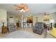 Open concept living room flowing into the kitchen and dining area, featuring neutral colors at 18701 N Diamond Dr, Surprise, AZ 85374