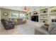 Comfortable living room featuring a large window, built-in shelving, and neutral color scheme at 18701 N Diamond Dr, Surprise, AZ 85374