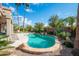 A sparkling pool with desert landscape, gravel, and palm trees at 18701 N Diamond Dr, Surprise, AZ 85374