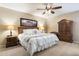 Comfortable bedroom with neutral colors, a ceiling fan, and wood furniture at 1873 Leisure World --, Mesa, AZ 85206