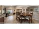 Well-lit dining area featuring wood floors, a classic wooden table, and a view of the kitchen at 1873 Leisure World --, Mesa, AZ 85206