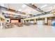 Large event space with tables, chairs, stage, wood floors, and beautiful light fixtures at 1873 Leisure World --, Mesa, AZ 85206