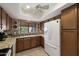 Bright kitchen with wooden cabinets, granite counters, white appliances and a view of the backyard at 1873 Leisure World --, Mesa, AZ 85206