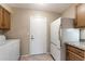 Functional laundry room featuring a washer, dryer, refrigerator, and ample storage space at 1873 Leisure World --, Mesa, AZ 85206