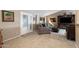 Inviting living room area featuring a comfortable gray sofa, carpet floors, and a large window for natural light at 1873 Leisure World --, Mesa, AZ 85206