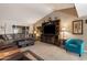 Cozy living room featuring a large entertainment center, plush seating, and a neutral color palette at 1873 Leisure World --, Mesa, AZ 85206