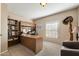 Home office featuring a large built-in desk, bookshelves, neutral tones, and a bright window for natural light at 1873 Leisure World --, Mesa, AZ 85206